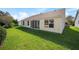 House exterior and spacious backyard with green grass at 306 Bishopville Loop # 117, The Villages, FL 32162