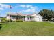 House exterior showcasing a well-maintained lawn and landscaping at 6401 Tildon, Leesburg, FL 34748