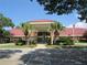 Community clubhouse with palm trees and flag at 6401 Tildon, Leesburg, FL 34748