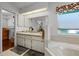 Bathroom with double vanity, a large soaking tub, and a walk-in shower at 6401 Tildon, Leesburg, FL 34748