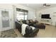 Comfortable living room with sectional sofa, TV, and access to pool area at 2019 Majorca Dr, Kissimmee, FL 34747