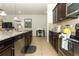 Granite kitchen island, stainless steel appliances, and dark brown cabinets at 2019 Majorca Dr, Kissimmee, FL 34747