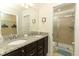 Bathroom with granite countertop, double sinks, and shower at 2019 Majorca Dr, Kissimmee, FL 34747