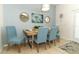 Casual dining area with a light wood table and blue chairs at 2019 Majorca Dr, Kissimmee, FL 34747
