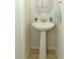 Small powder room with pedestal sink and oval mirror at 2019 Majorca Dr, Kissimmee, FL 34747