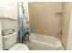 Bathroom with tub and shower, and beach-themed decor at 2019 Majorca Dr, Kissimmee, FL 34747