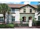 Two-story townhome with a Spanish-style roof and a well-maintained front yard at 2019 Majorca Dr, Kissimmee, FL 34747