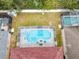 Aerial view of a home with a screened pool and spa at 4415 Great Harbor Ln, Kissimmee, FL 34746