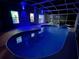 Inviting pool area with blue lighting at night at 4415 Great Harbor Ln, Kissimmee, FL 34746