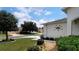 Landscaped front yard with mature trees and a walkway to the front door at 16360 Sw 15Th Ct, Ocala, FL 34473