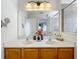 Bathroom with double sinks, wood cabinets, and a shower at 426 Orange Cosmos Blvd, Davenport, FL 33837