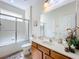 Clean bathroom with a shower/tub combo and wood vanity at 426 Orange Cosmos Blvd, Davenport, FL 33837