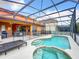 Relaxing pool and spa with screened enclosure at 426 Orange Cosmos Blvd, Davenport, FL 33837