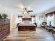 Main bedroom with wood flooring and a large bed at 426 Orange Cosmos Blvd, Davenport, FL 33837