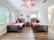 ' bedroom with twin beds, wood flooring, and ceiling fan at 426 Orange Cosmos Blvd, Davenport, FL 33837