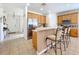 Kitchen features wood cabinets, stainless steel appliances, and an island with seating at 426 Orange Cosmos Blvd, Davenport, FL 33837