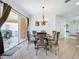 Bright dining room with glass-top table and four chairs, near sliding door to patio at 426 Orange Cosmos Blvd, Davenport, FL 33837