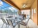 Covered patio with seating area and grill overlooking pool at 426 Orange Cosmos Blvd, Davenport, FL 33837