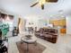 Relaxing living room with leather reclining sofas and a ceiling fan at 426 Orange Cosmos Blvd, Davenport, FL 33837