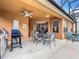 Covered patio with seating area and grill, pool view at 426 Orange Cosmos Blvd, Davenport, FL 33837