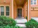 Front door entry with arched entryway, and adjacent two-car garage at 426 Orange Cosmos Blvd, Davenport, FL 33837