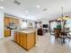 Open kitchen with light wood cabinets, island, and breakfast bar at 426 Orange Cosmos Blvd, Davenport, FL 33837