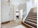 Bright and spacious entryway with tiled floors and staircase at 426 Orange Cosmos Blvd, Davenport, FL 33837