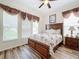 Primary bedroom with floral comforter and wood flooring at 426 Orange Cosmos Blvd, Davenport, FL 33837
