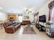 Spacious living room with comfortable leather sofas and a large TV at 426 Orange Cosmos Blvd, Davenport, FL 33837