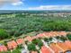 Aerial view of houses with orange roofs and pools in a community at 426 Orange Cosmos Blvd, Davenport, FL 33837