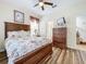 Primary bedroom with a floral comforter and wood dresser at 426 Orange Cosmos Blvd, Davenport, FL 33837
