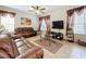 Living area features two leather sofas, a coffee table, and large screen TV at 426 Orange Cosmos Blvd, Davenport, FL 33837