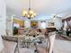 Bright dining area with glass table and seating for six, adjacent to kitchen at 426 Orange Cosmos Blvd, Davenport, FL 33837