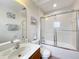 Bright bathroom with a tub shower combo and wood vanity at 426 Orange Cosmos Blvd, Davenport, FL 33837