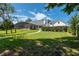 White farmhouse with a large backyard and screened pool at 26012 Splendid Meadow Ct, Astatula, FL 34705