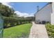Landscaped yard with a brick pathway and privacy hedge at 26012 Splendid Meadow Ct, Astatula, FL 34705
