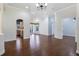 Open concept living room with hardwood floors and views into the kitchen area at 26012 Splendid Meadow Ct, Astatula, FL 34705