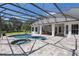 Spacious patio and screened pool with a hot tub at 26012 Splendid Meadow Ct, Astatula, FL 34705