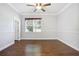 Simple bedroom with hardwood floors and a window at 26012 Splendid Meadow Ct, Astatula, FL 34705