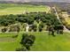 Aerial view showing a home with detached garage and lush landscaping at 26012 Splendid Meadow Ct, Astatula, FL 34705
