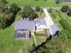 Aerial view showing house, pool, and outbuildings at 26012 Splendid Meadow Ct, Astatula, FL 34705
