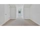 Bright hallway with neutral walls and carpet, featuring a window at 26012 Splendid Meadow Ct, Astatula, FL 34705