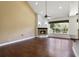 Bright living room with a corner fireplace and hardwood floors at 26012 Splendid Meadow Ct, Astatula, FL 34705