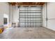 Large garage with a roll-up door, offering easy access for vehicles at 26012 Splendid Meadow Ct, Astatula, FL 34705