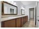 Double vanity bathroom with wood cabinets and tiled floor at 26012 Splendid Meadow Ct, Astatula, FL 34705