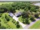 Aerial view of a home with a long driveway, pool, and detached garage at 26012 Splendid Meadow Ct, Astatula, FL 34705