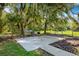 Outdoor grilling area under shade of large oak trees at 26012 Splendid Meadow Ct, Astatula, FL 34705