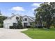 House exterior with driveway and landscaping at 26012 Splendid Meadow Ct, Astatula, FL 34705