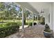 Inviting front porch with brick pavers and views of a lush green landscape at 26012 Splendid Meadow Ct, Astatula, FL 34705