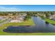 Aerial view of a home and community with a canal at 120 Trailwood Dr, Leesburg, FL 34748